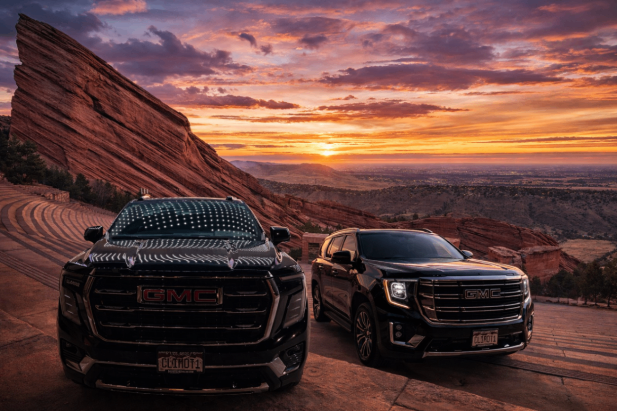 Two black GMC Yukons at Red Rocks Amphitheater at sunset
